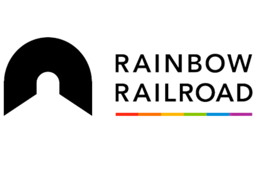 An underlined black logo that reads “Rainbow Railroad.” The underline itself features the colors of the rainbow.