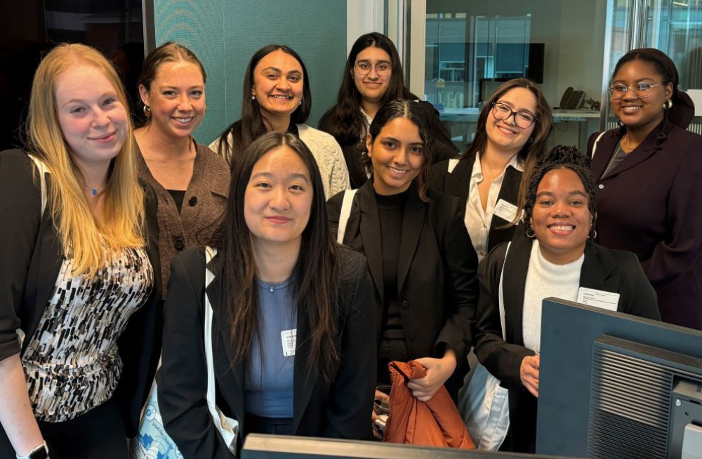 A group of young women standing together and smiling.